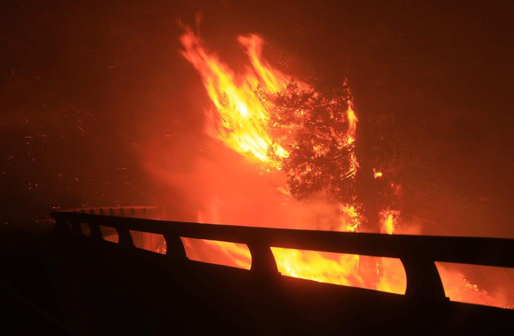 The Tubbs fire jumps Highway 101 at the Mendocino overcrossing in Santa Rosa, Monday Oct. 9, 2017. (Kent Porter / Press Democrat) 2017