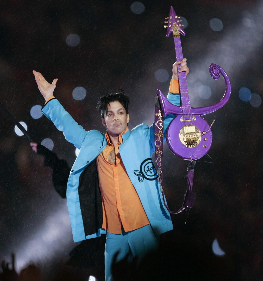 FILE - In this Feb. 4, 2007 file photo, Prince performs during halftime of the Super Bowl XLI football game in Miami. Minnesota prosecutors are planning an announcement Thursday, April 19, 2018, in their two-year investigation into Prince's death. Prince was found alone and unresponsive in an elevator at his Paisley Park estate on April 21, 2016. An autopsy found he died of an accidental overdose of fentanyl, a synthetic opioid 50 times more powerful than heroin. (AP Photo/Chris O'Meara, File)