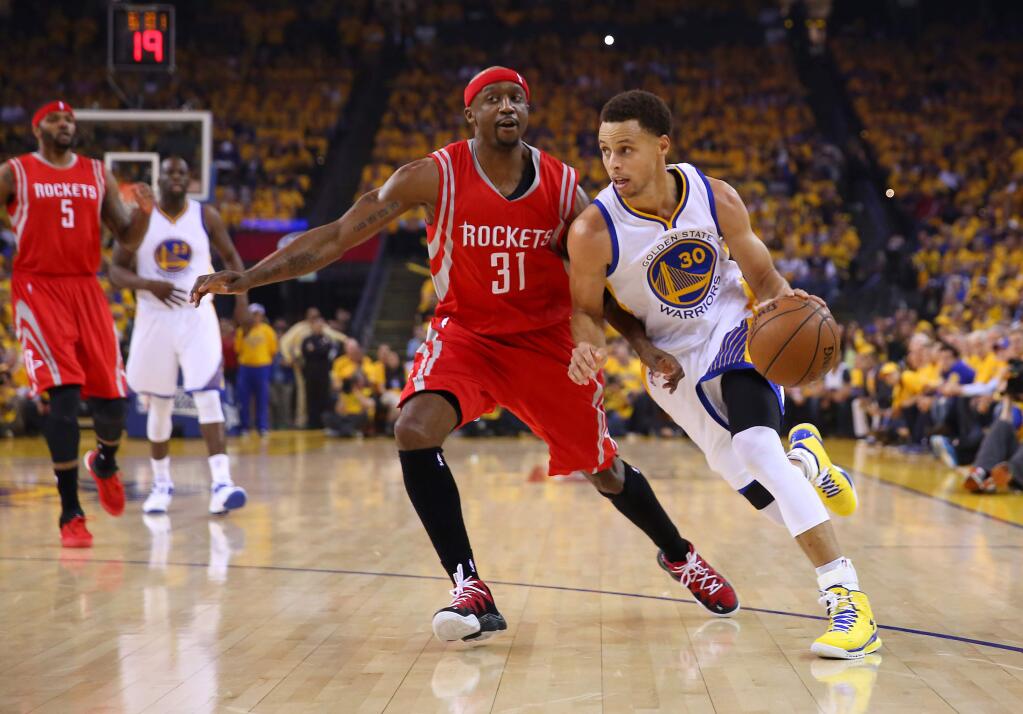 Golden State Warriors guard Stephen Curry drives against Houston Rockets guard Jason Terry during Game 2 of the Western Conference finals at Oracle Arena in Oakland on Thursday, May 21, 2015. The Warriors defeated the Rockets 99-98. (Christopher Chung / The Press Democrat)