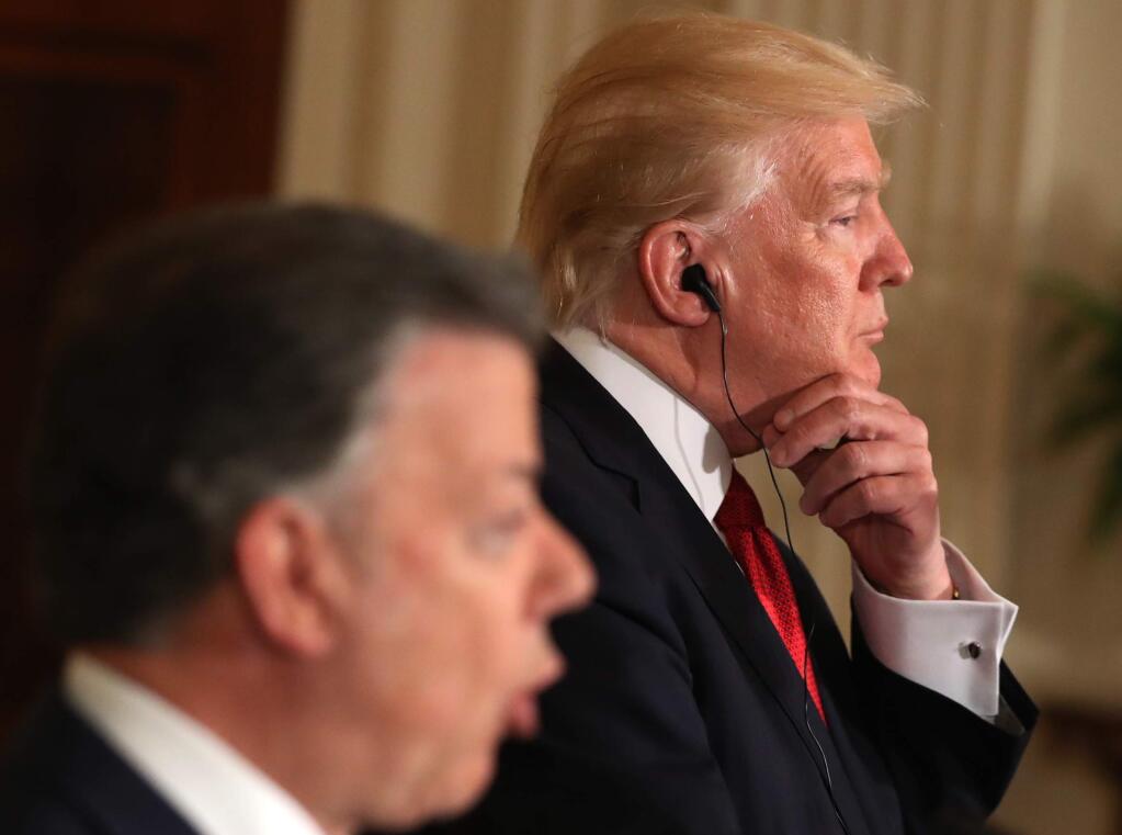 President Donald Trump listens as Colombian President Juan Manuel Santos speaks during a joint news conference in the East Room of the White House in Washington, Thursday, May, 18, 2017. (AP Photo/Andrew Harnik)