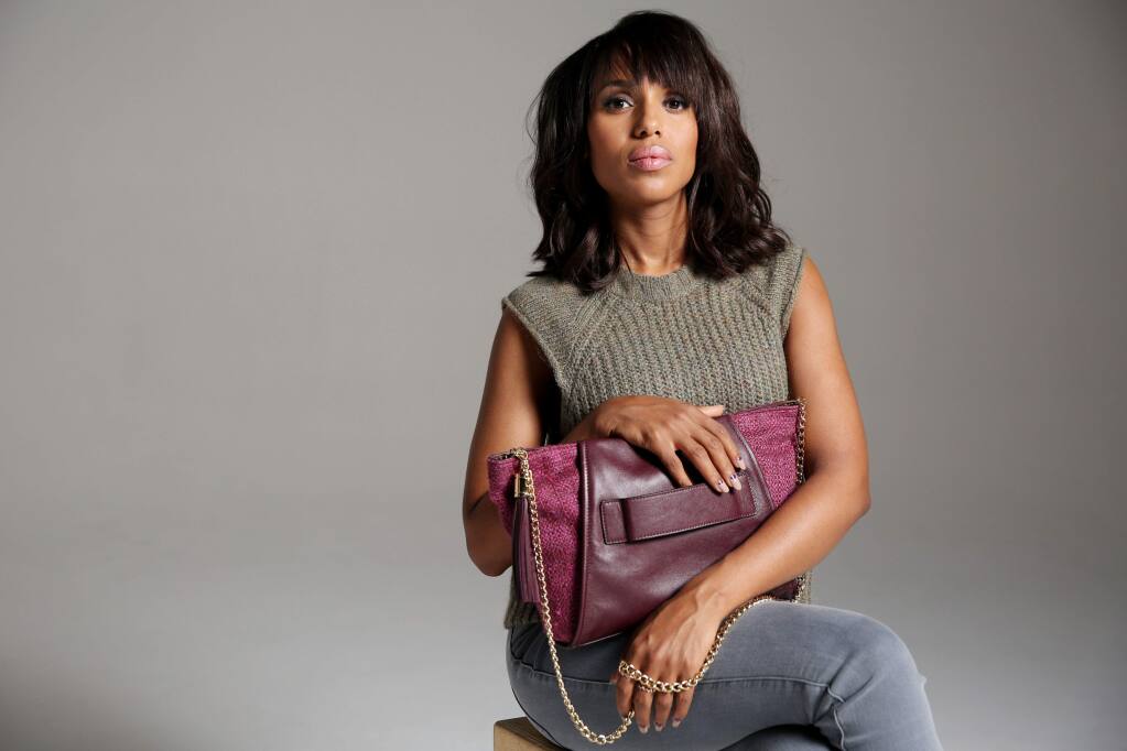 In this Sunday, Sept. 7, 2014 photo, actress Kerry Washington poses for a portrait in Los Angeles. Washington was asked to do the domestic abuse public service announcement by The Allstate Foundation, which had already put into motion an initiative called Purple Purse, to raise awareness of domestic-abuse money matters. Washington said the facts and figures were such eye openers, she immediately agreed to serve as the campaign's spokesperson. (Photo by Matt Sayles/Invision/AP)