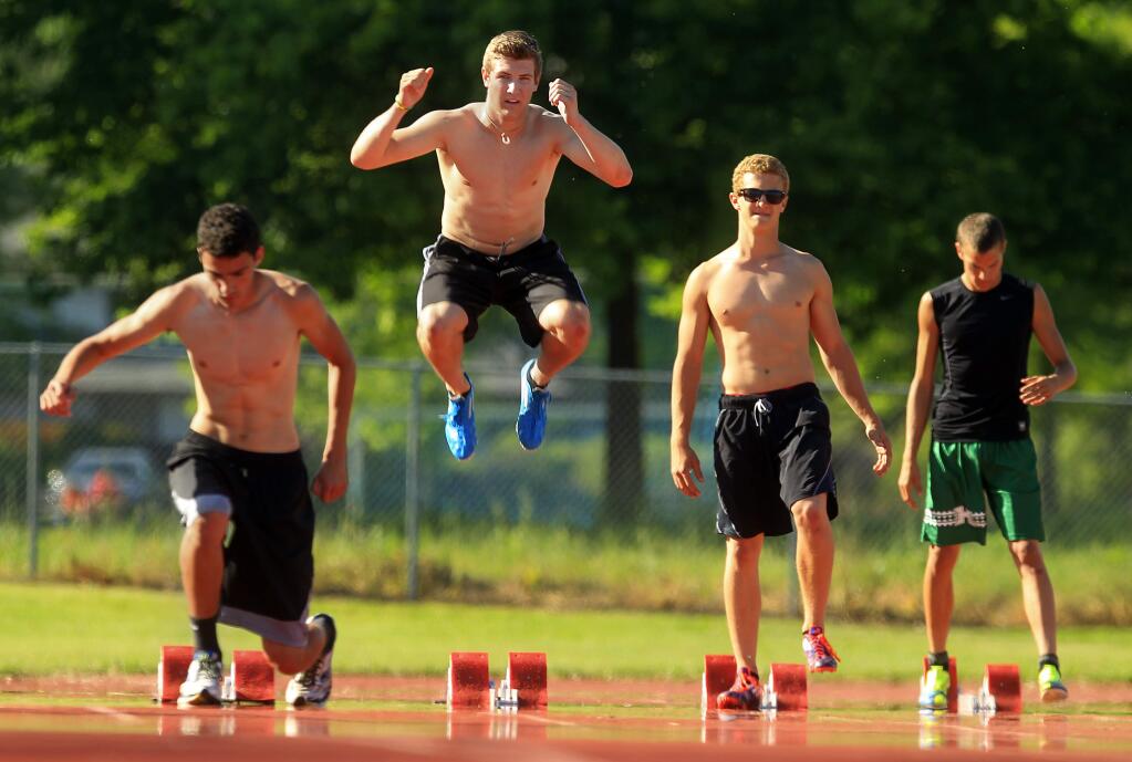 Maria Carrillo hurdler Alex Netherda, jumping, says that if he qualifies, he will skip his graduation to attend the state track finals. Also pictured are, left to right, Isaiah Smith, Spencer Netherda and Jordan Rosado. (JOHN BURGESS / The Press Democrat)