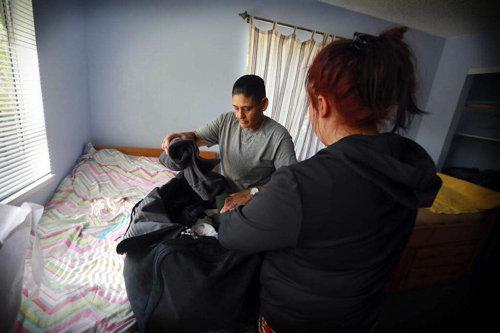 Youth Advocate Ruth Adrade helps one of the foster kids in R House pack her bag on her last day at the group home for foster kids with mental illness and drug addictions in Santa Rosa. The home will close because of financial problems after finding proper placements for the remaining teens. (John Burgess/The Press Democrat)