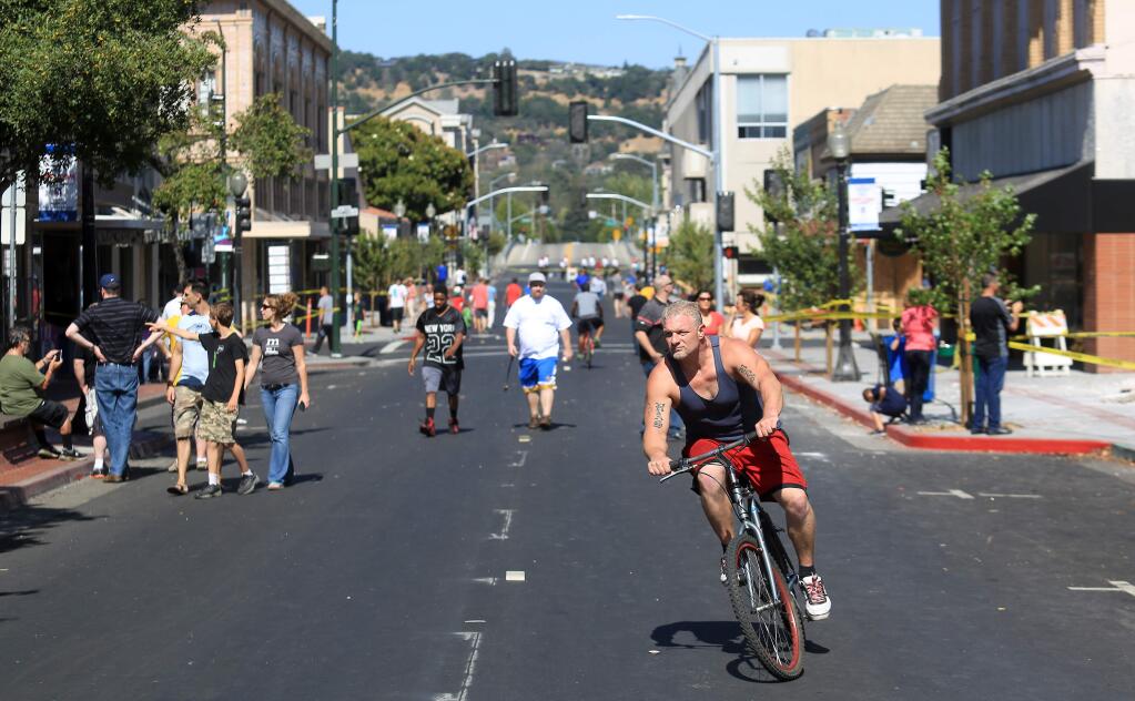 Dowtown Napa was closed off to traffic, but an almost festive type atmosphere evolved as locals, and tourists gawped at the damage from the Sunday Aug. 24, 6.0 temblor. (Kent Porter / Press Democrat) 2014