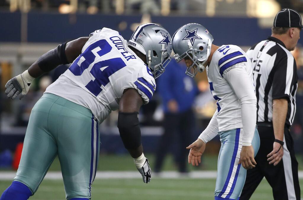 Dallas Cowboys guard Jonathan Cooper (64) congratulates Dan Bailey (5) on his field goal against the Seattle Seahawks, Sunday, Dec. 24, 2017, in Arlington, Texas. The 49ers signed Cooper on Tuesday. (AP Photo/Ron Jenkins)