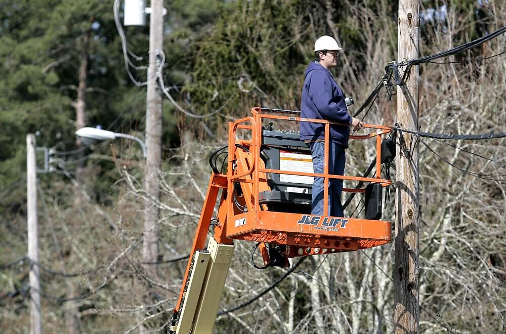Sonic.net outside plant engineer Mario Rubio survey's phone poles for a location to place fiber optic cable that the company says will deliver 1 Gbps internet speed in Sebastopol, Thursday Mar. 18, 2010. (Kent Porter / The Press Democrat) 2010