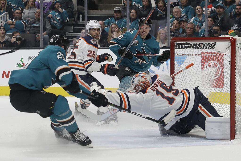 Edmonton Oilers goaltender Mikko Koskinen, bottom right, defends a shot by San Jose Sharks right wing Timo Meier during the first period in San Jose, Tuesday, Nov. 20, 2018. (AP Photo/Jeff Chiu)