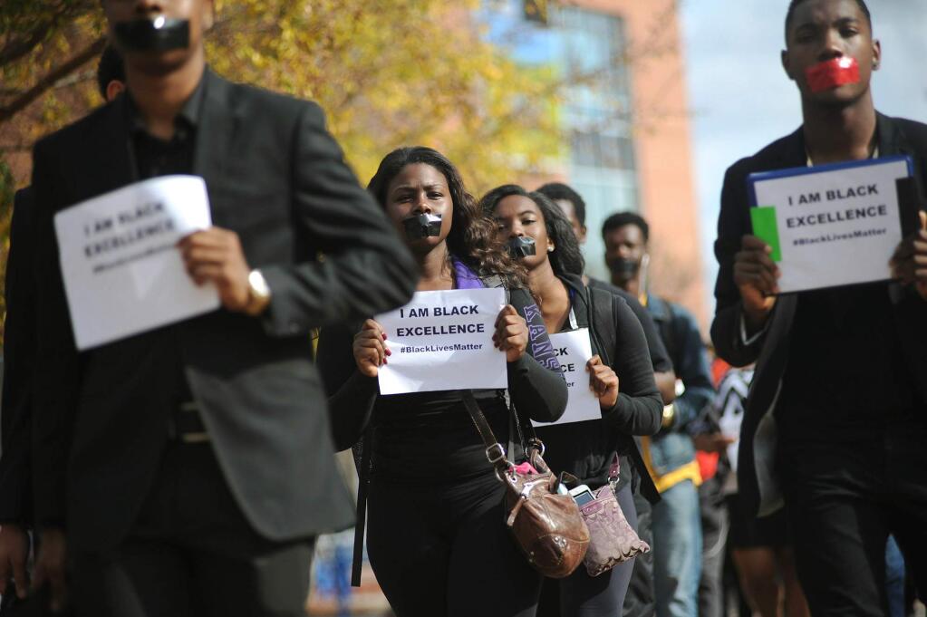 Students at Jackson State University participate in the national Hands Up Walkout on Monday, Dec. 1, 2104, at the Gibbs-Green Plaza on the school's Jackson, Mississippi, campus. Protesters across the U.S. have walked off their jobs or away from classes in support of the Ferguson protesters. (AP Photo/The Clarion-Ledger, Joe Ellis)