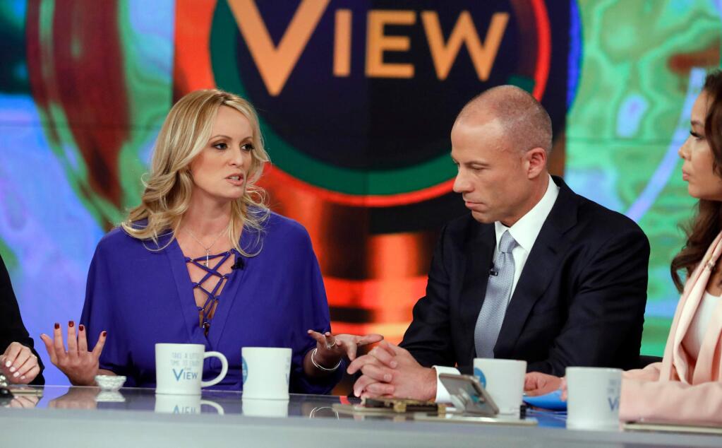 This image released by ABC shows adult film actress Stormy Daniels, left, with her attorney Michael Avenatti during an appearance on the daytime talk show 'The View,' Tuesday, April 17, 2018, in New York. Daniels released a composite sketch Tuesday of the man she says threatened her in a Las Vegas parking lot to stay quiet about her past sexual tryst with President Donald Trump. Avenatti says they are offering $100,000 for information leading to the man's identification. (Heidi Gutman/ABC via AP)