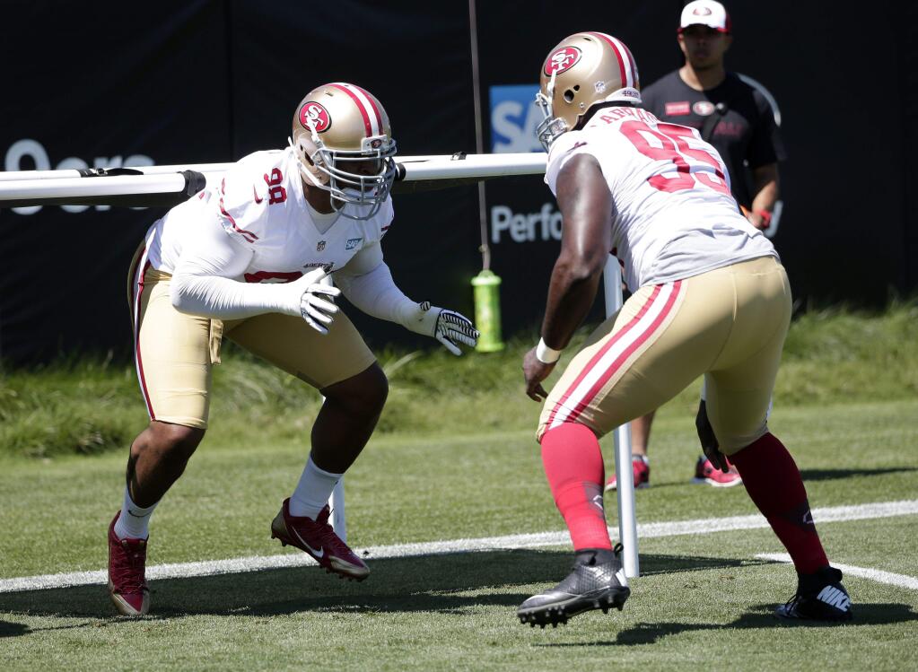 Two to watch in preseason opener: San Francisco 49ers lineman Lawrence Okoye, left, runs a drill with teammate Tank Carradine (95) during training camp. (Associated Press photo)
