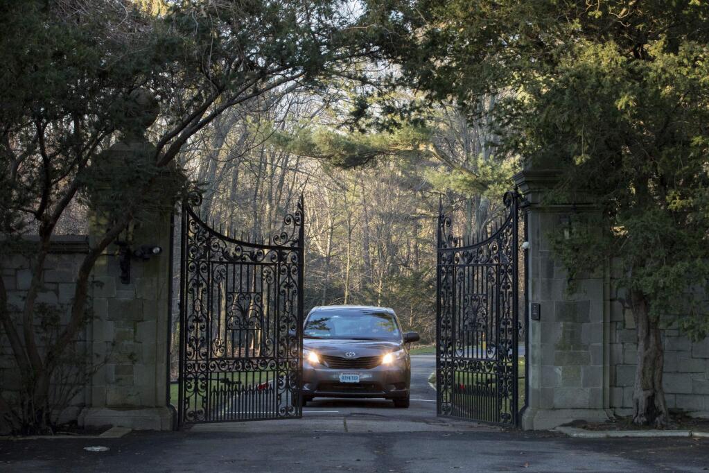 A car with diplomatic license plates drives out of a compound near Glen Cove, N.Y., on Long Island on Friday, Dec. 30, 2016. Russia maintains this and another weekend retreat for its United Nations diplomats about an hour's drive outside New York City - each in one of Long Island's old Gold Coast mansions. U.S. officials didn't clarify which of the two countryside compounds would be closed. (AP Photo/Alexander F. Yuan)