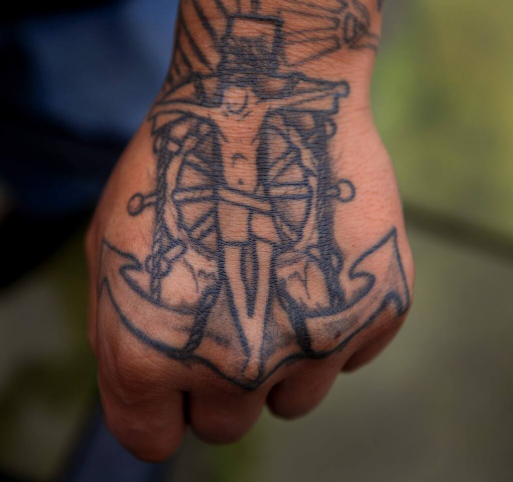 A tattoo on deckhand Wilton Cruz, Friday, Dec. 13, 2019 as fishermen prepare for the opening of crab season in Bodega Bay. (Kent Porter / The Press Democrat) 2019