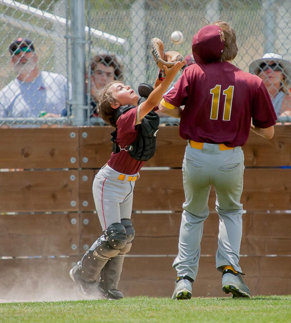 McNear's catcher Rocco Palmini grabs a pop foul in City Championship game won by Peterson's Paint, 3-1.