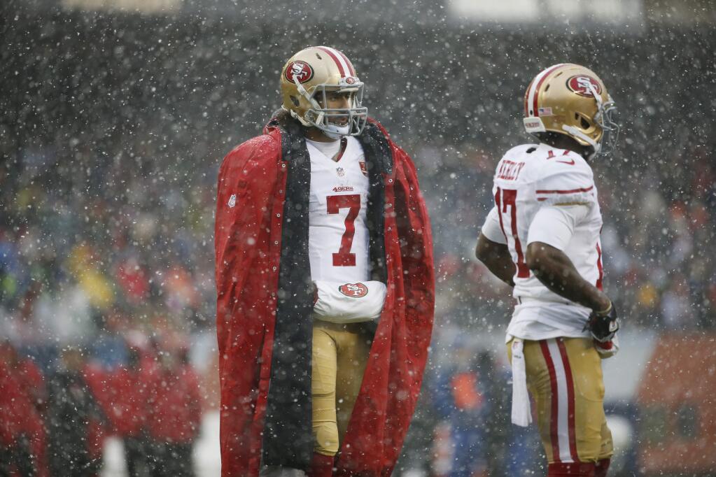 San Francisco 49ers quarterback Colin Kaepernick (7) stands on the sidelines during the first half of an NFL football game against the Chicago Bears Sunday, Dec. 4, 2016, in Chicago. (AP Photo/Nam Y. Huh)
