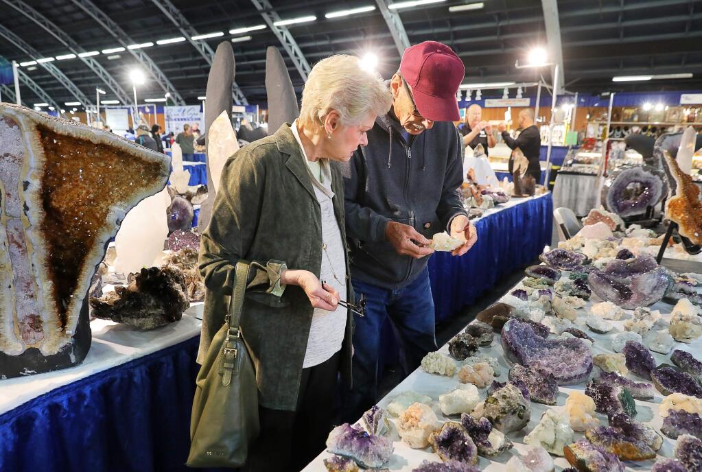 Jan and Tom Sloan look at geodes in the Elegant Healing booth at the Gem Faire, at the Sonoma County Event Center at the Fairgrounds, in Santa Rosa on Friday, January 4, 2019. (Christopher Chung/ The Press Democrat)