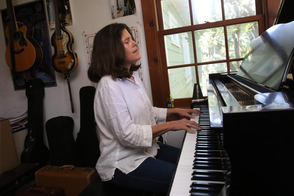 Amy Hogan plays piano in her home studio on Monday, April 18, 2016. (SCOTT MANCHESTER/ARGUS-COURIER STAFF)