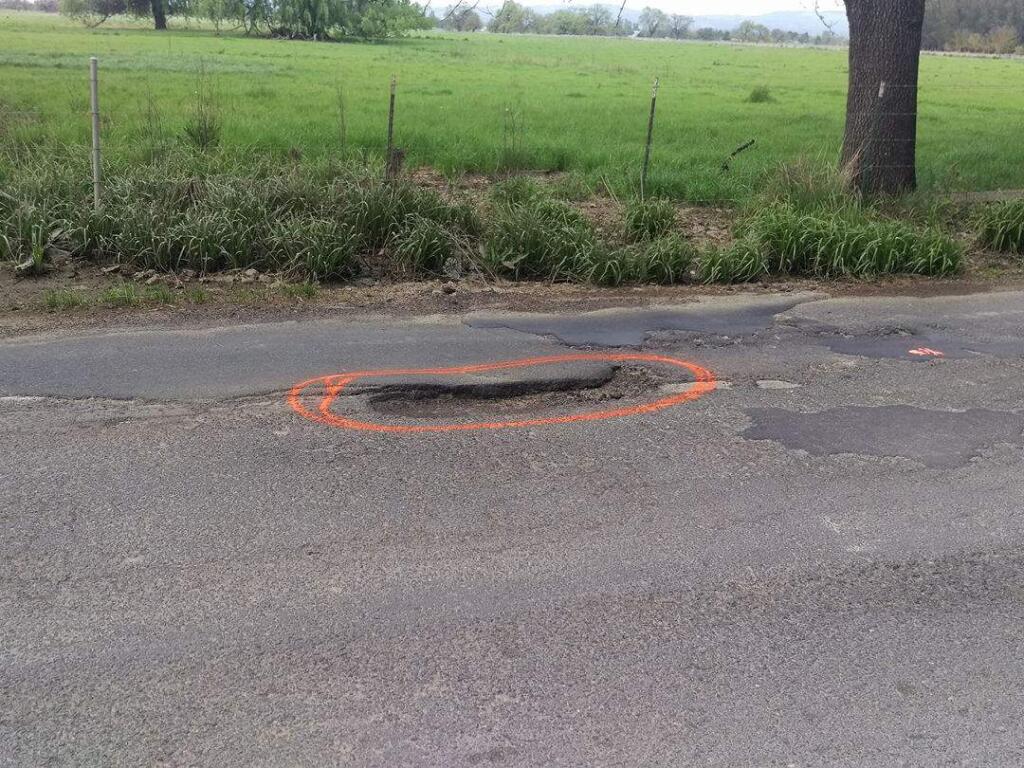 A Sonoma County couple have dubbed themselves the “Pothole Bandits.” On their Facebook page, they say they're just “two people who find the condition of Sonoma County roads deplorable. We can't fill 'em, but we can point 'em out!” (COURTESY PHOTO)