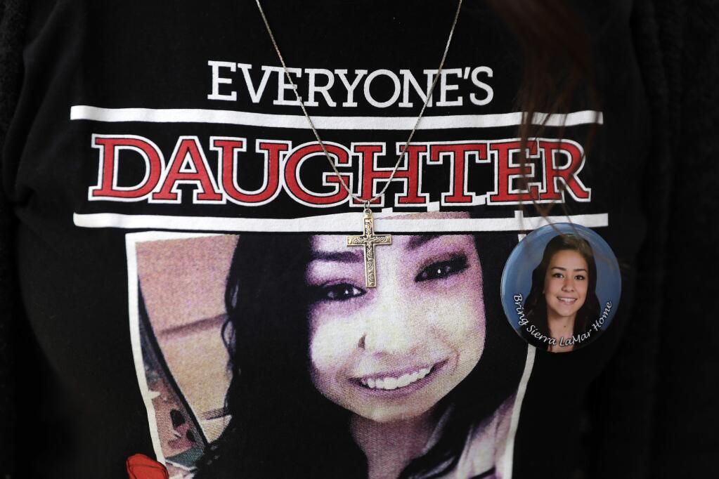 A supporter wears a T-shirt with an image of Sierra LaMar outside of the Santa Clara County Hall of Justice on Tuesday, May 9, 2017, in San Jose, Calif. A jury found Antolin Garcia-Torres guilty of the killing and kidnapping of Sierra LaMar in 2012. Sierra disappeared on her way to a school bus stop near her home in Morgan Hill. (AP Photo/Marcio Jose Sanchez)