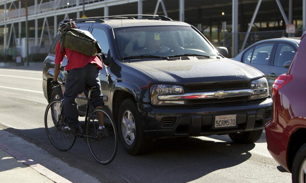 DAMIAN DOVARGANES / Associated PressA new state law requires cars to give bicycles three feet of clearance.