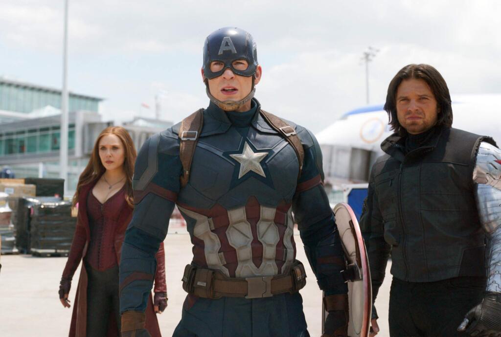 This image released by Disney shows Elizabeth Olsen, left, Chris Evans and Sebastian Stan in a scene from Marvel's 'Captain America: Civil War.' (Disney/Marvel via AP)