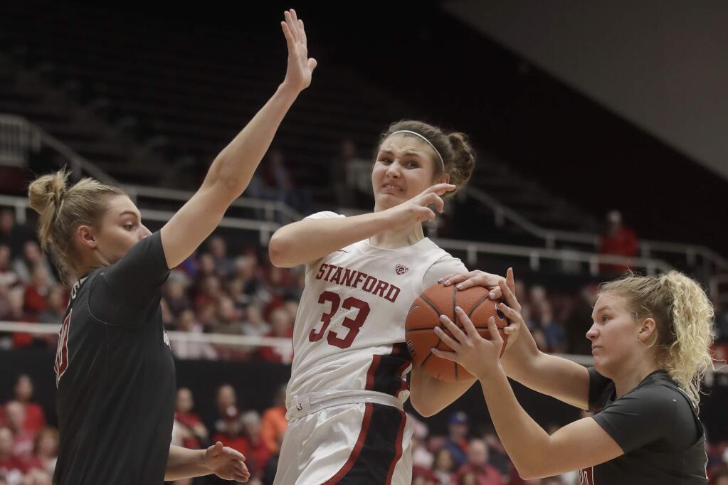 Stanford guard Hannah Jump, middle, is defended by Washington State guards Johanna Muzet, left, and Grace Sarver during the first half of an NCAA college basketball game in Stanford, Calif., Friday, Jan. 3, 2020. (AP Photo/Jeff Chiu)