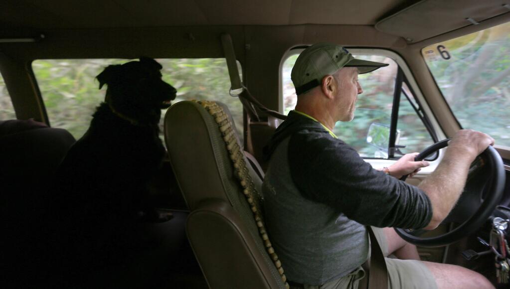 Larry Laba, president of SOAR (Somewhere On A River) in Healdsburg and his dog Indy, head to the river to give a safety speech to customers preparing to take a self guided Russian River float trip, Wednesday May 20, 2015 in Healdsburg. (Kent Porter / Press Democrat) 2015