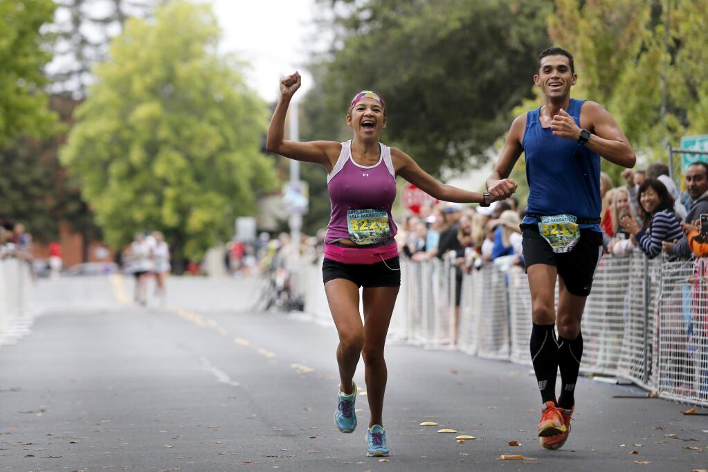 Veronica and Steven Nieto cross the finish line of the Santa Rosa Half Marathon in Santa Rosa, on Sunday, August 23, 2015. (BETH SCHLANKER/ The Press Democrat)