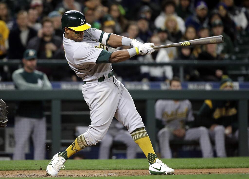 Oakland Athletics' Khris Davis homers against the Seattle Mariners in the fourth inning of a baseball game, Monday, May 15, 2017, in Seattle. (AP Photo/Elaine Thompson)