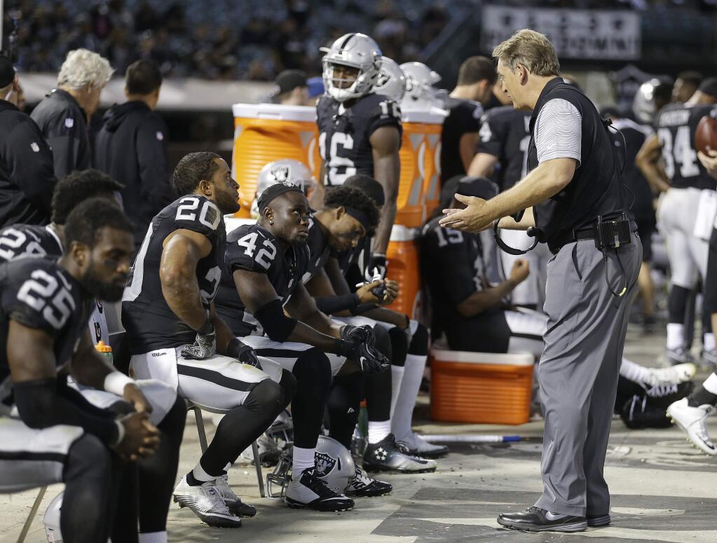 Oakland Raiders head coach Jack Del Rio gestures toward safety Karl Joseph (42) and strong safety Nate Allen (20) sitting on the bench during the second half of an NFL preseason football game against the Tennessee Titans Saturday, Aug. 27, 2016, in Oakland, Calif. Tennessee won the game 27-14. (AP Photo/Ben Margot)