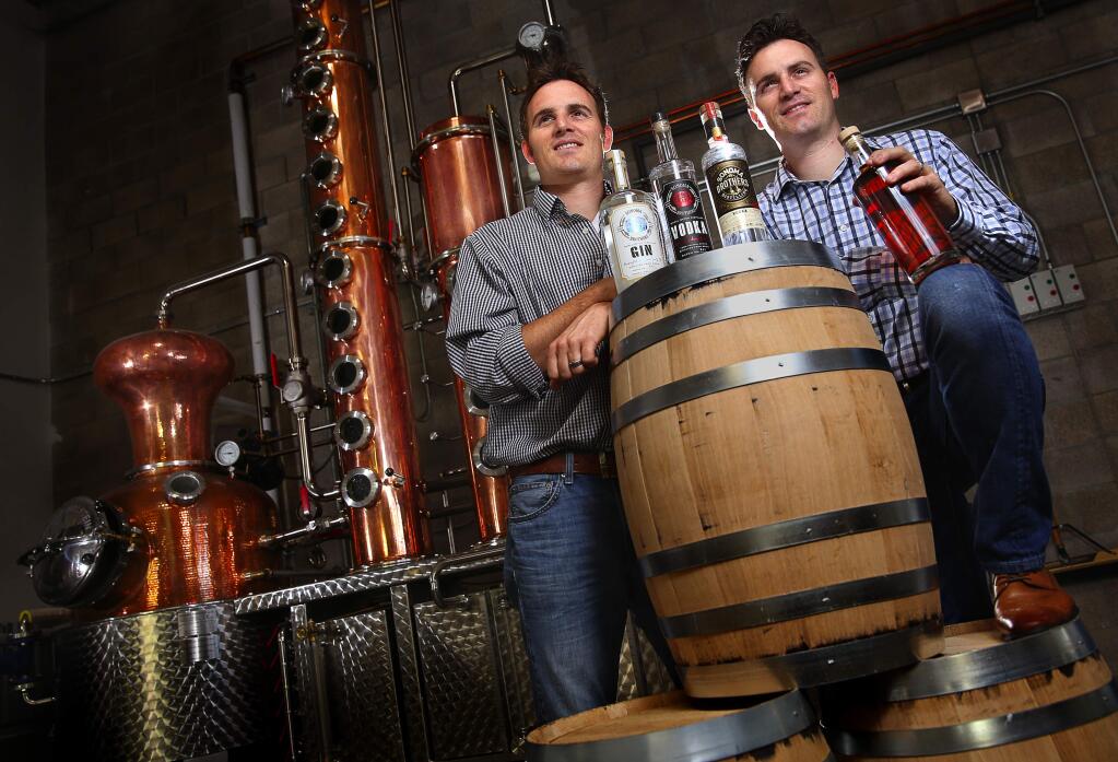 Twin brothers Chris, left, and Brandon Matthies own and operate Sonoma Brothers Distilling, in Windsor. The brothers produce their own line of gin, vodka and whiskey in their handmade Arnold Holstein copper pot still.(Christopher Chung/ The Press Democrat)