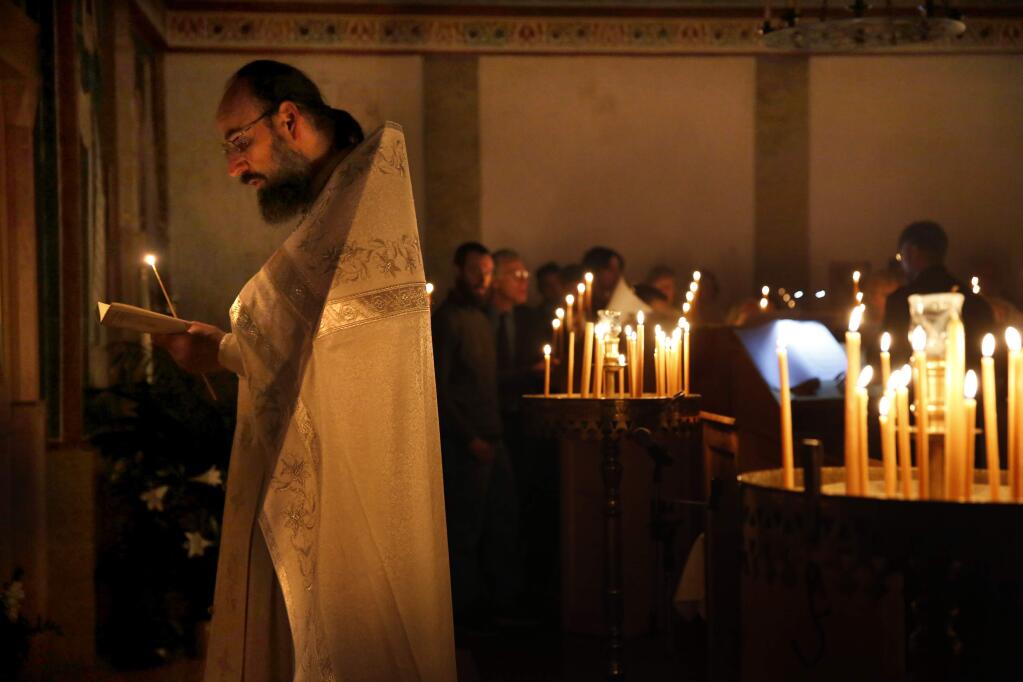 Father Lawrence chants prayers before the start of a three-hour Pascha service at St. Seraphim of Sarov Orthodox Church. (BETH SCHLANKER/ The Press Democrat)