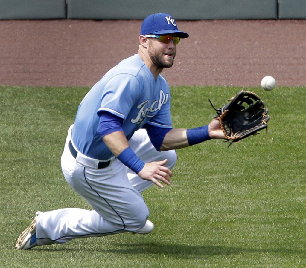 Kansas City Royals left fielder Alex Gordon catches a fly ball for the out on Minnesota Twins' Trevor Plouffe during the ninth inning of a baseball game Sunday, July 5, 2015, in Kansas City, Mo. The Royals won 3-2. (AP Photo/Charlie Riedel)