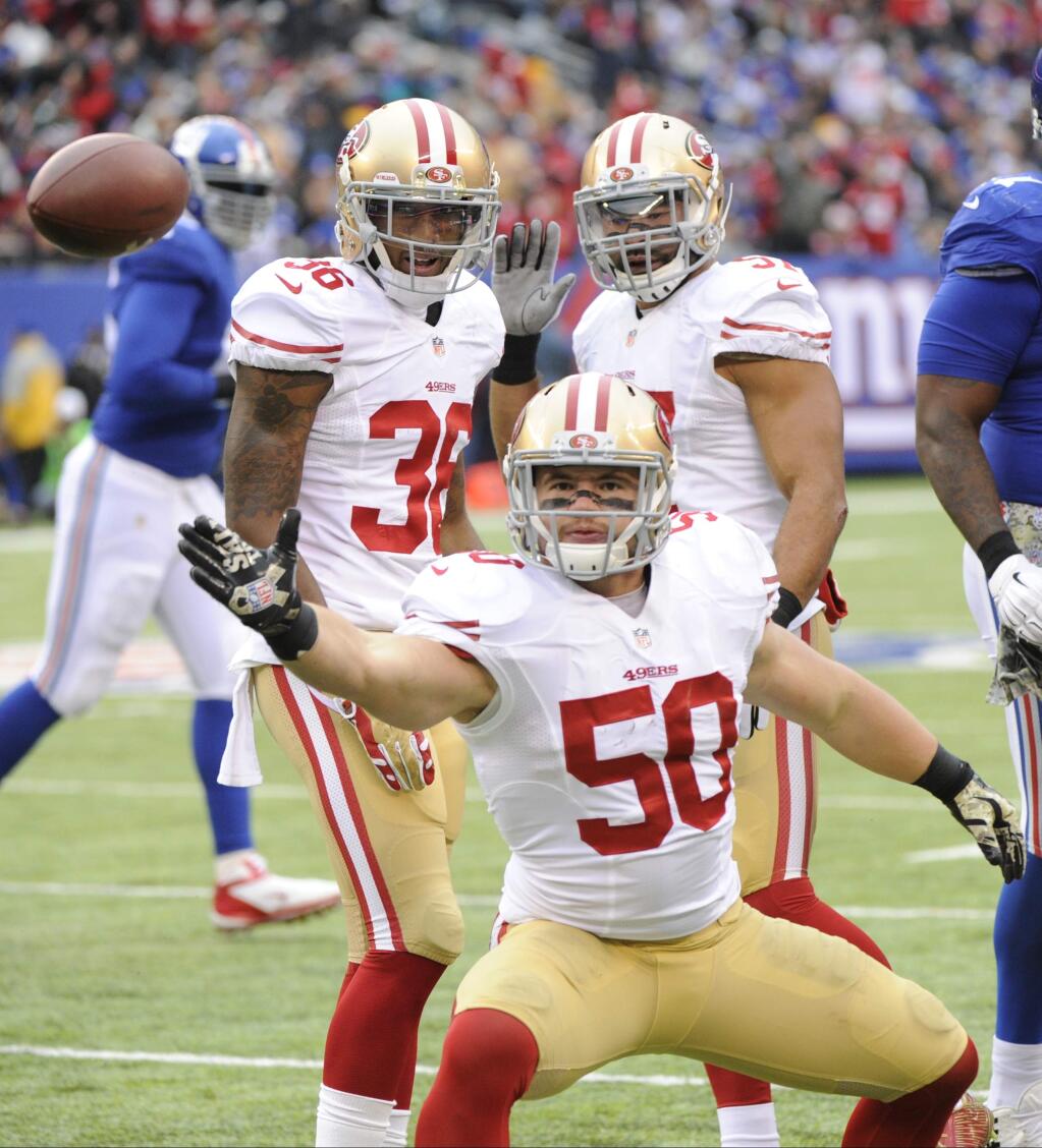 San Francisco 49ers inside linebacker Chris Borlandcelebrates after intercepting a pass during the first half against the New York Giants, Sunday, Nov. 16, 2014, in East Rutherford, N.J. (AP Photo/Bill Kostroun)
