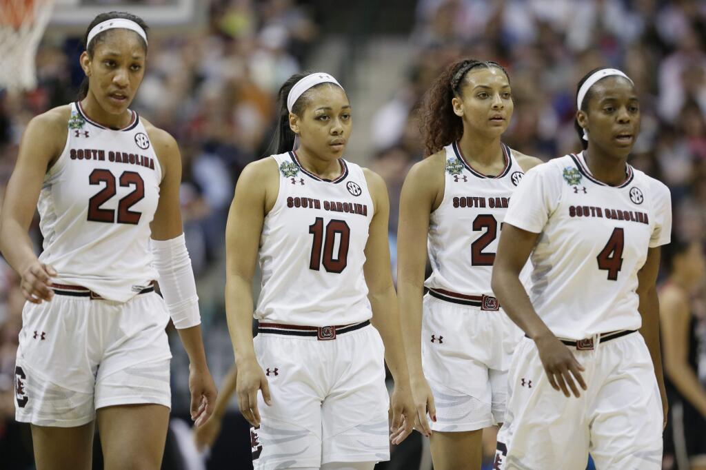 South Carolina players A'ja Wilson (22), Allisha Gray (10), Mikiah Herbert Harrigan and Doniyah Cliney (4) walk off the court during a timeout in the first half of an NCAA college basketball game against Stanford in the semifinals of the women's Final Four, Friday, March 31, 2017, in Dallas.(AP Photo/Tony Gutierrez)