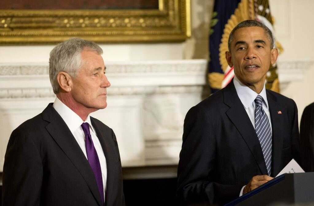 President Barack Obama, standing with Defense Secretary Chuck Hagel, talks about Hagel's resignation during an event in the State Dining Room of the White House in Washington, Monday, Nov. 24, 2014. Hagel is stepping down under pressure from Obama's Cabinet, senior administration officials said Monday, following a tenure in which he has struggled to break through the White House's insular foreign policy team. (AP Photo/Pablo Martinez Monsivais)
