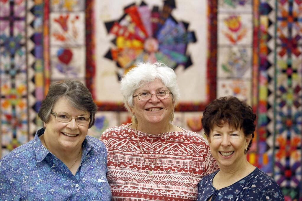 (From left) Diana Watson, Pam Beebe, and Toni Anderson, all members of the Santa Rosa Quilt Guild, lost their homes during the Tubbs fire. Photo taken during a quiltathon at Luther Burbank Art and Garden in Santa Rosa on Thursday, May 31, 2018. (Beth Schlanker/ The Press Democrat)