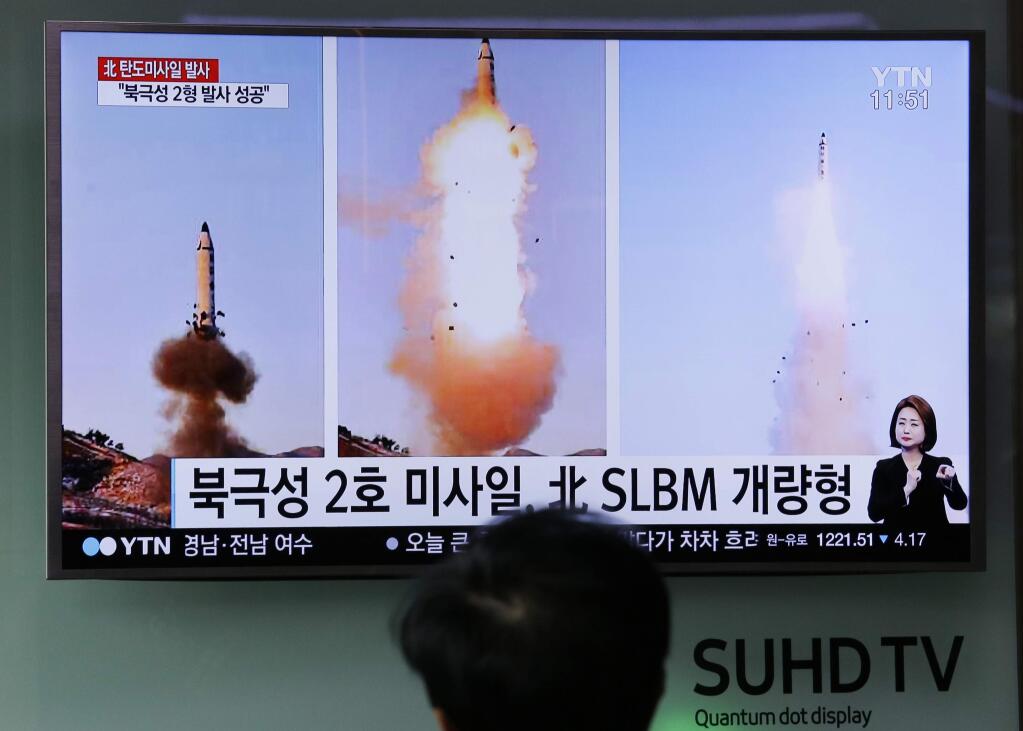 A Korean TV news program showing photos published in North Korea's Rodong Sinmun newspaper of North Korea's 'Pukguksong-2' missile launch last month. (AHN YOUNG-JOON / Associated Press)