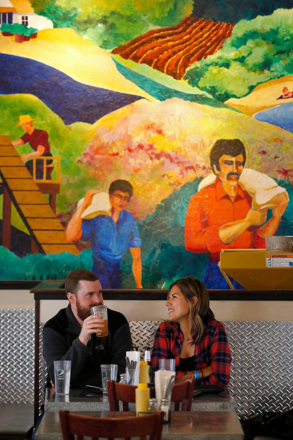 Noah Schmidt and Emily McClelland of Santa Rosa enjoy some drinks at Bear Republic Brewing Company's taproom in Healdsburg, California, on Saturday, October 19, 2019. Bear Republic Brewing Company recently announced the closing of their original brewpub in Healdsburg, after 25 years of operation. (Alvin Jornada / The Press Democrat)