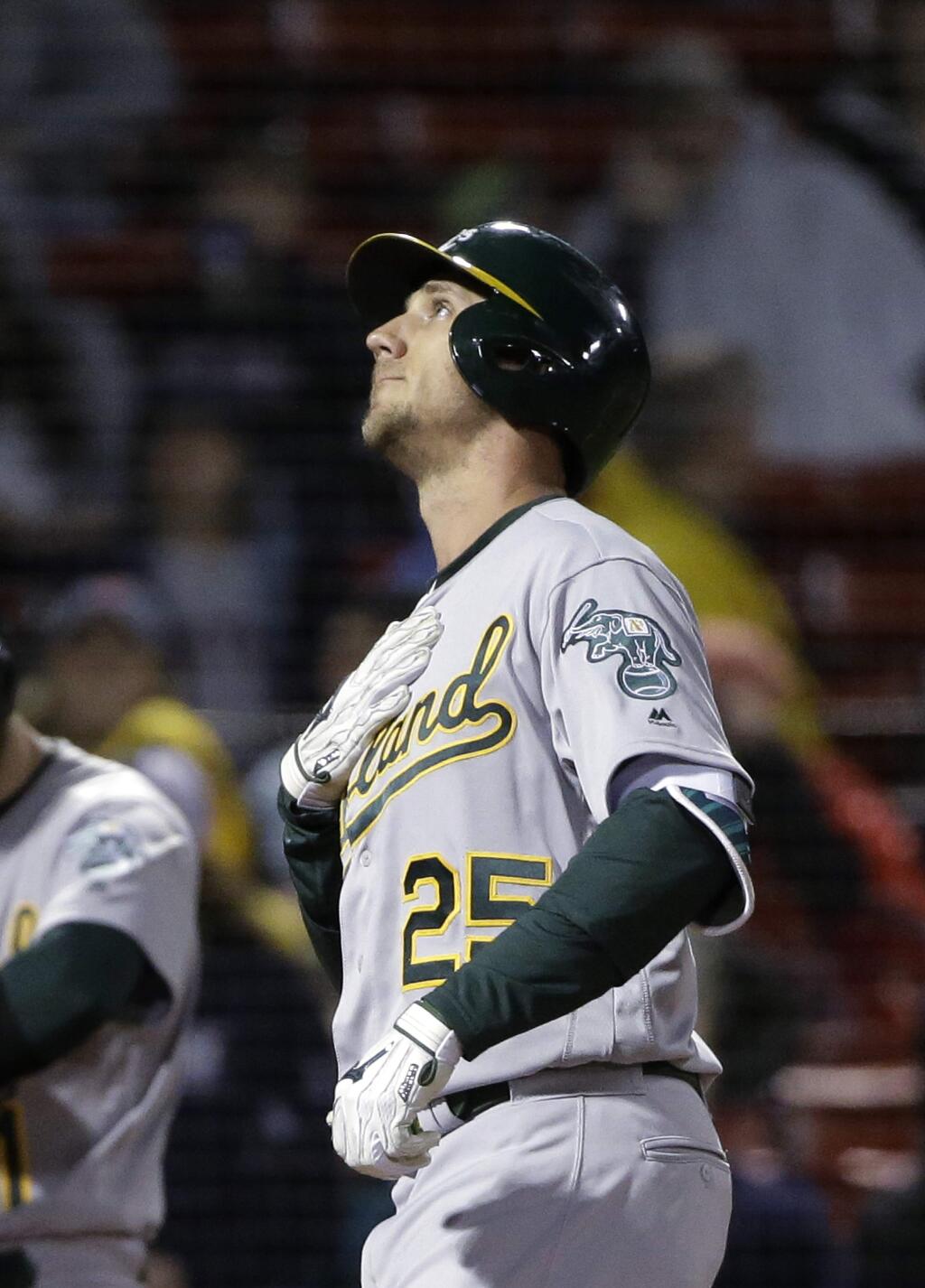 The Oakland Athletics' Stephen Piscotty looks up as he arrives at home plate after hitting a home run off Boston Red Sox's Eduardo Rodriguez during the second inning Tuesday, May 15, 2018, in Boston. (AP Photo/Steven Senne)