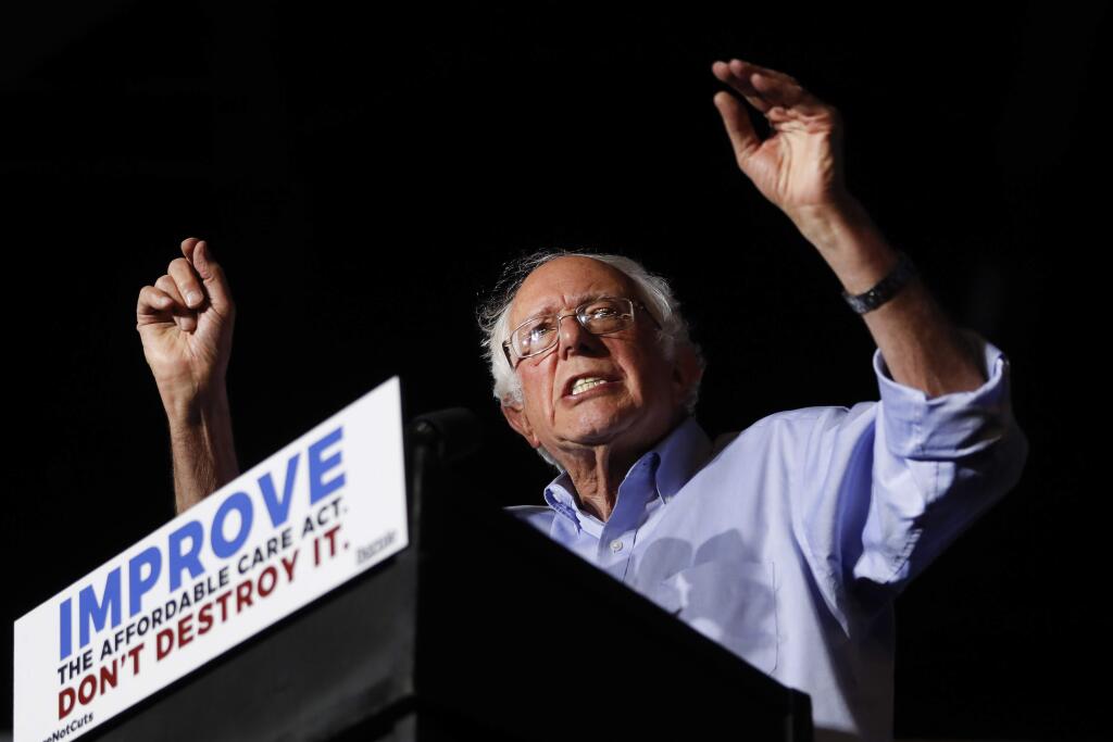 In this July 9, 2017 photo, Sen. Bernie Sanders, I-Vt., speaks during a 'Care Not Cuts' rally in support of the Affordable Care Act in Covington, Ky. House Minority Leader Nancy Pelosi is declining to endorse Sen. Bernie Sanders' universal health care bill saying that while she has long supported the idea the bill captures, of everybody getting health coverage, 'Right now I'm protecting the Affordable Care Act.' (AP Photo/John Minchillo)