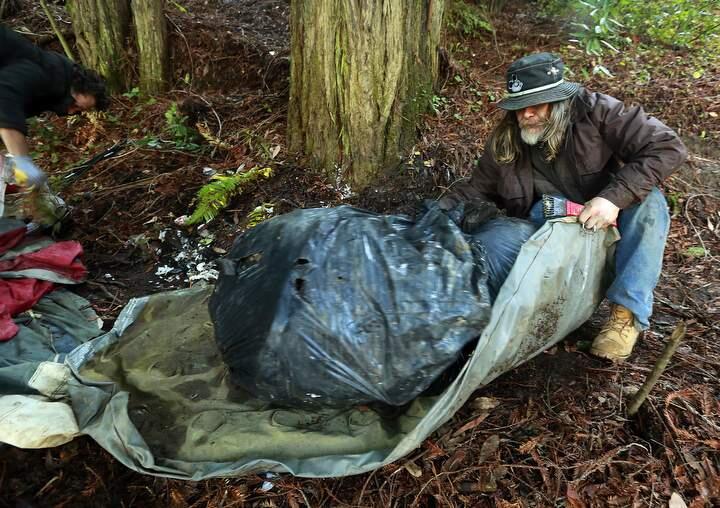 John Burgess / The Press DemocratShawn Whiting struggles with piles of trash he and other homeless people collected from their camp during a cleanup effort along the Russian River in Guerneville sponsored by the Russian Riverkeeper.