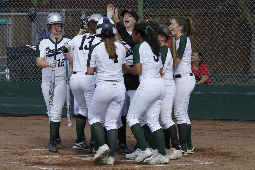 Sonoma Valley's girls softball team is almost all on the field to welcome runners home in the 19-0 victory over Elsie Allen. (Bill Hoban/Index-Tribune)
