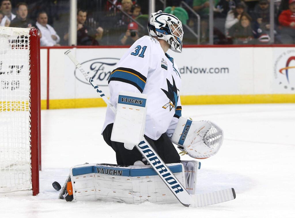 San Jose Sharks goaltender Martin Jones (31) reacts after a goal by New Jersey Devils right wing Kyle Palmieri during the second period of an NHL hockey game, Sunday, Oct. 14, 2018, in Newark,N.J. (AP Photo/ Noah K. Murray)