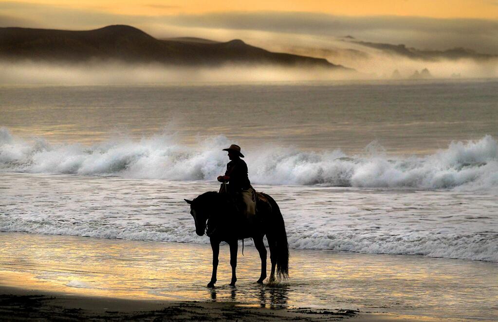Eddyann Filipini of Battle Mountain, Nevada, waits in the surf at Doran Beach in Bodega Bay for the start of a horse relay ride across the United States to protest grazing rights in her state.