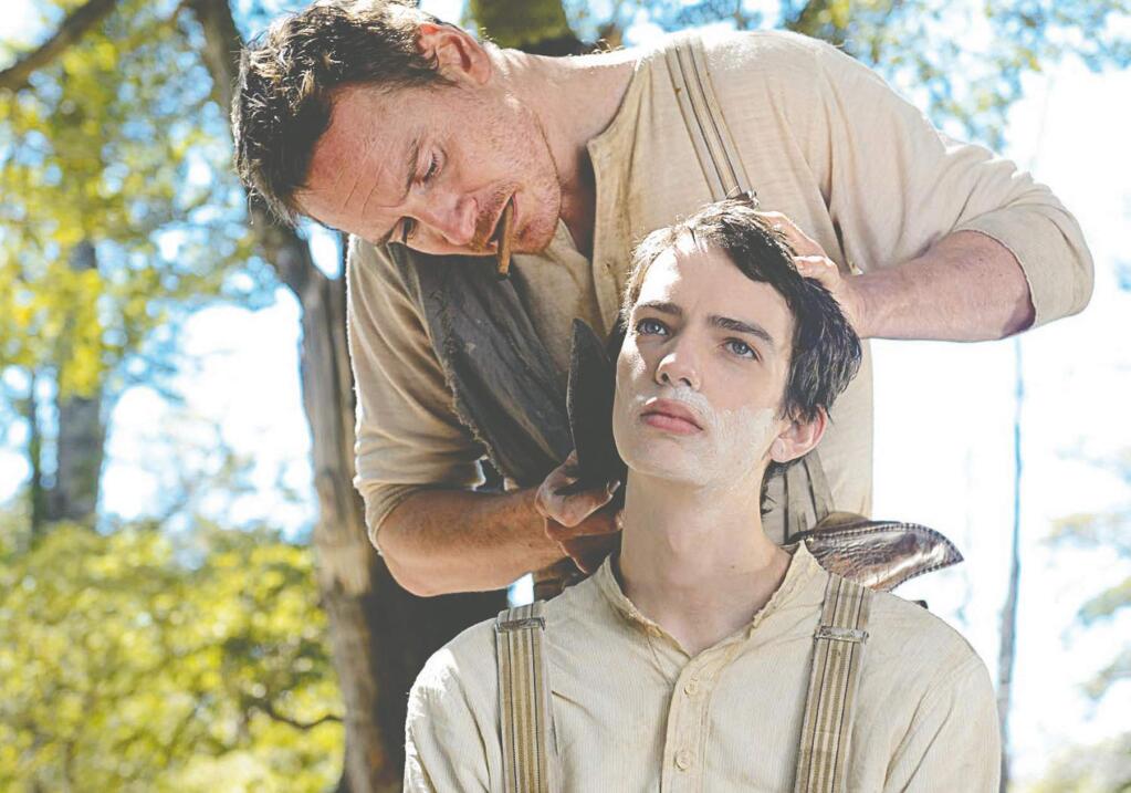 Kodi Smit-McPhee (foreground) and Michael Fassbender in “Slow West.” (A24)