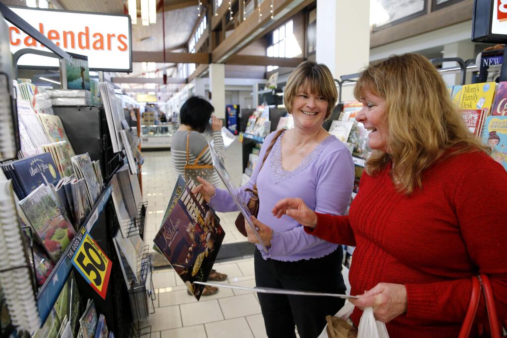 Sisters Lorin Rose, left, and Jolen Philbrook shop for calendars marked at 50 percent off at Coddingtown Mall on Tuesday, December 26, 2017 in Santa Rosa, California . (BETH SCHLANKER/The Press Democrat)