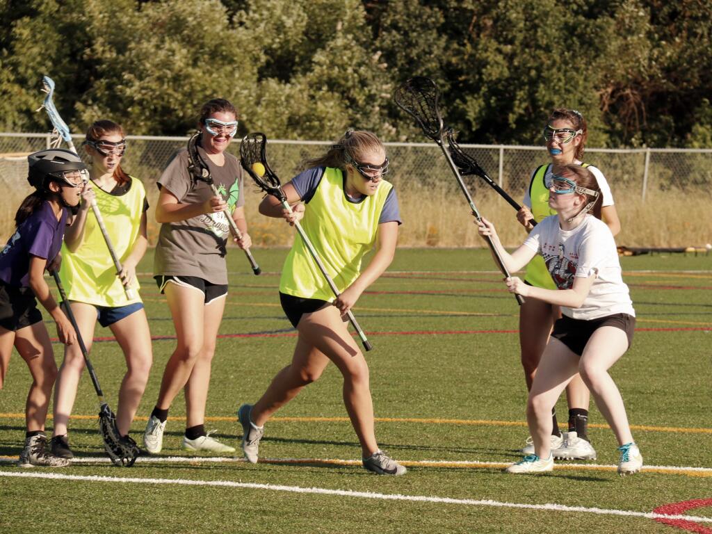 A pick-up game of lacrosse, an increasingly popular high school sport in the North Bay, finds Emi Biaggi, Reese Dobson, Julia Lage, Hannah Walton, Maria Mountanos (in back) and Mary Gallo chasing the action at Adele Harrison Middle School on Wednesday, June 12. (Christian Kallen/Index-Tribune)
