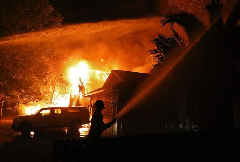 A Santa Rosa resident hosing down his house as the Tubbs fire approaches. Dr. Stephen Seager's 'Urban Inferno,' focuses on telling the stories of those affected by the firestorm. (CHRISTOPHER CHUNG/ PD FILE)