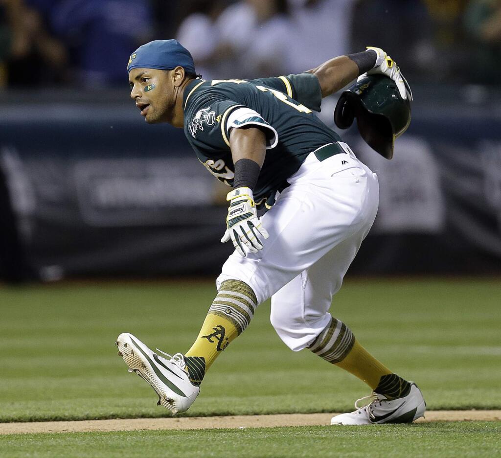 The Oakland Athletics' Khris Davis celebrates after hitting a two-run home run off Cleveland Indians' Bryan Shaw during the ninth inning Saturday, July 15, 2017, in Oakland. The A's won 5-3. (AP Photo/Ben Margot)