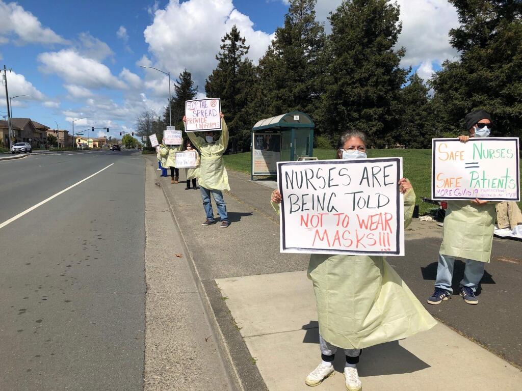 Petaluma Valley Hospital Nurses staged a picket outside the hospital on March 25 to draw attention to the lack of safety equipment. The equipment they are wearing is expired. MATT BROWN/ARGUS-COURIER STAFF